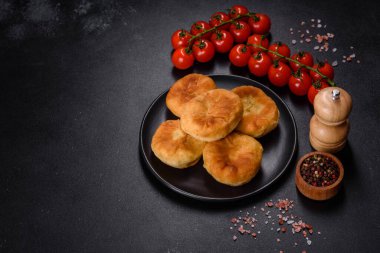 Traditional homemade pies with cabbage and sauerkraut on the plate on a concrete table