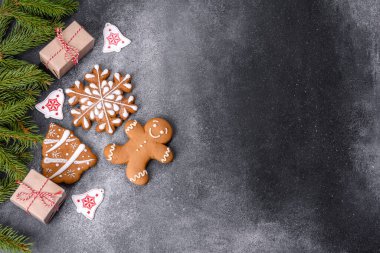 Gingerbread, Christmas tree decorations, dried citrus fruits on a gray concrete background to prepare a festive Christmas table