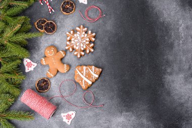 Gingerbread, Christmas tree decorations, dried citrus fruits on a gray concrete background to prepare a festive Christmas table