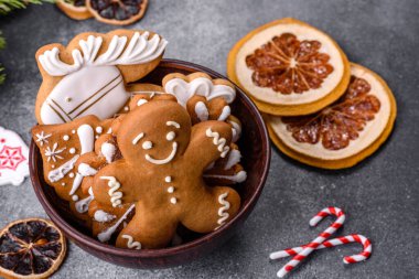 Gingerbread, Christmas tree decorations, dried citrus fruits on a gray concrete background to prepare a festive Christmas table