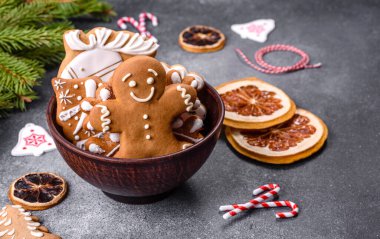 Gingerbread, Christmas tree decorations, dried citrus fruits on a gray concrete background to prepare a festive Christmas table