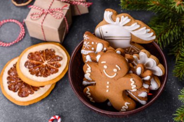 Gingerbread, Christmas tree decorations, dried citrus fruits on a gray concrete background to prepare a festive Christmas table