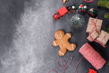 Gingerbread, Christmas tree decorations, dried citrus fruits on a gray concrete background to prepare a festive Christmas table