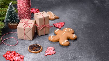Gingerbread, Christmas tree decorations, dried citrus fruits on a gray concrete background to prepare a festive Christmas table