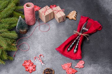 Gingerbread, Christmas tree decorations, dried citrus fruits on a gray concrete background to prepare a festive Christmas table