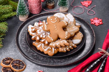 Gingerbread, Christmas tree decorations, dried citrus fruits on a gray concrete background to prepare a festive Christmas table