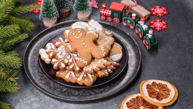 Gingerbread, Christmas tree decorations, dried citrus fruits on a gray concrete background to prepare a festive Christmas table