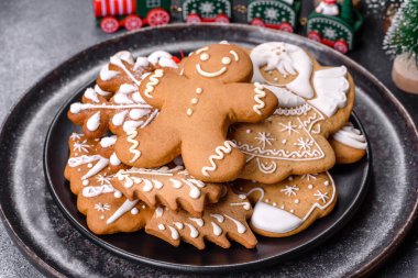 Gingerbread, Christmas tree decorations, dried citrus fruits on a gray concrete background to prepare a festive Christmas table