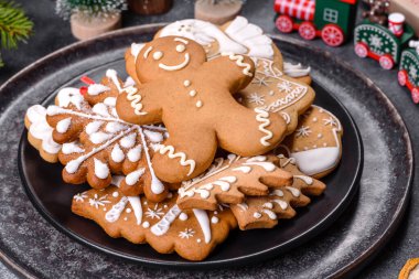 Gingerbread, Christmas tree decorations, dried citrus fruits on a gray concrete background to prepare a festive Christmas table