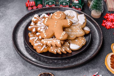 Gingerbread, Christmas tree decorations, dried citrus fruits on a gray concrete background to prepare a festive Christmas table