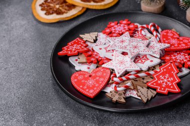 Gingerbread, Christmas tree decorations, dried citrus fruits on a gray concrete background to prepare a festive Christmas table