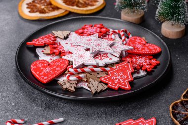 Gingerbread, Christmas tree decorations, dried citrus fruits on a gray concrete background to prepare a festive Christmas table
