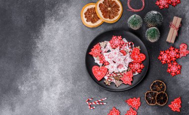 Gingerbread, Christmas tree decorations, dried citrus fruits on a gray concrete background to prepare a festive Christmas table
