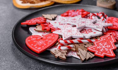 Gingerbread, Christmas tree decorations, dried citrus fruits on a gray concrete background to prepare a festive Christmas table