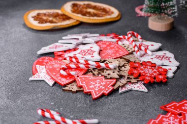 Gingerbread, Christmas tree decorations, dried citrus fruits on a gray concrete background to prepare a festive Christmas table