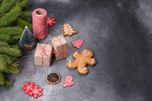 Gingerbread, Christmas tree decorations, dried citrus fruits on a gray concrete background to prepare a festive Christmas table