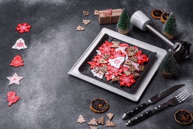 Christmas decorations and gingerbreads on a dark concrete table. Preparing and decorating the house for holiday