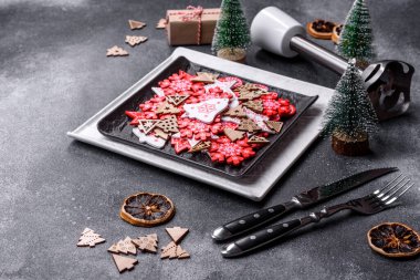 Christmas decorations and gingerbreads on a dark concrete table. Preparing and decorating the house for holiday