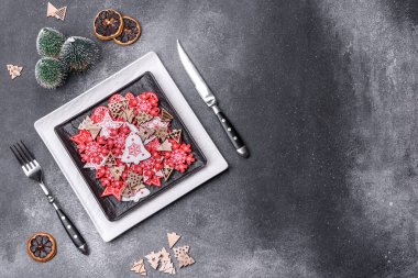 Christmas decorations and gingerbreads on a dark concrete table. Preparing and decorating the house for holiday