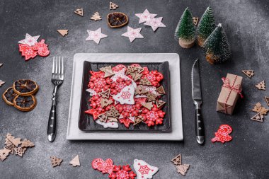 Christmas decorations and gingerbreads on a dark concrete table. Preparing and decorating the house for holiday