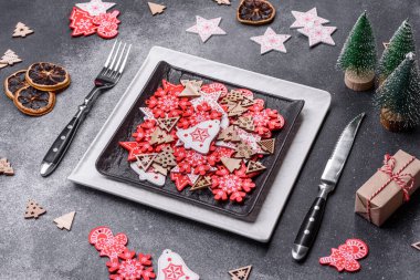 Christmas decorations and gingerbreads on a dark concrete table. Preparing and decorating the house for holiday