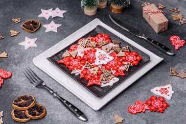 Christmas decorations and gingerbreads on a dark concrete table. Preparing and decorating the house for holiday