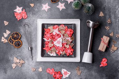 Christmas decorations and gingerbreads on a dark concrete table. Preparing and decorating the house for holiday