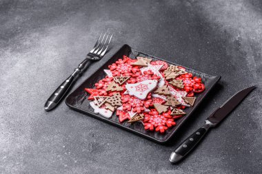 Christmas decorations and gingerbreads on a dark concrete table. Preparing and decorating the house for holiday