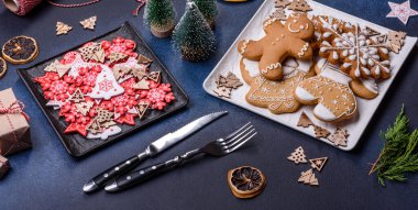 Christmas decorations and gingerbreads on a dark concrete table. Preparing and decorating the house for holiday