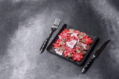 Christmas decorations and gingerbreads on a dark concrete table. Preparing and decorating the house for holiday