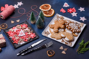 Christmas decorations and gingerbreads on a dark concrete table. Preparing and decorating the house for holiday