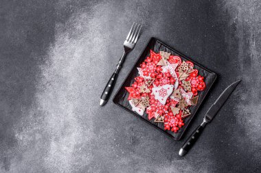 Christmas decorations and gingerbreads on a dark concrete table. Preparing and decorating the house for holiday