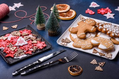 Christmas decorations and gingerbreads on a dark concrete table. Preparing and decorating the house for holiday