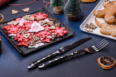 Christmas decorations and gingerbreads on a dark concrete table. Preparing and decorating the house for holiday