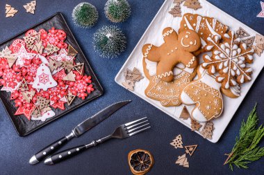 Christmas decorations and gingerbreads on a dark concrete table. Preparing and decorating the house for holiday