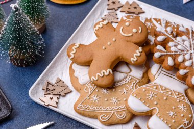 Christmas decorations and gingerbreads on a dark concrete table. Preparing and decorating the house for holiday