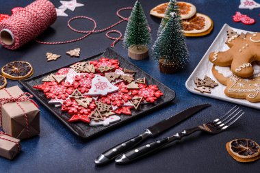 Christmas decorations and gingerbreads on a dark concrete table. Preparing and decorating the house for holiday