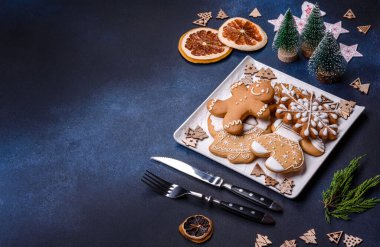 Christmas decorations and gingerbreads on a dark concrete table. Preparing and decorating the house for holiday