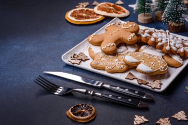 Christmas decorations and gingerbreads on a dark concrete table. Preparing and decorating the house for holiday