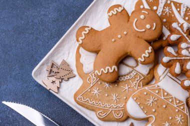 Christmas decorations and gingerbreads on a dark concrete table. Preparing and decorating the house for holiday