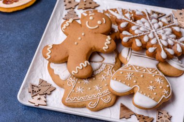 Christmas decorations and gingerbreads on a dark concrete table. Preparing and decorating the house for holiday