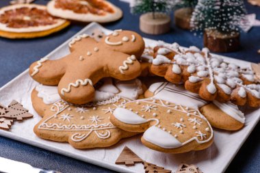 Christmas decorations and gingerbreads on a dark concrete table. Preparing and decorating the house for holiday