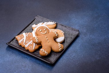 Christmas decorations and gingerbreads on a dark concrete table. Preparing and decorating the house for holiday