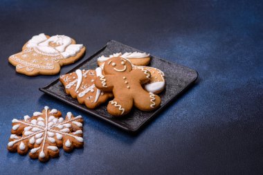 Christmas decorations and gingerbreads on a dark concrete table. Preparing and decorating the house for holiday