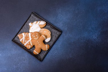 Christmas decorations and gingerbreads on a dark concrete table. Preparing and decorating the house for holiday
