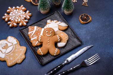 Christmas decorations and gingerbreads on a dark concrete table. Preparing and decorating the house for holiday