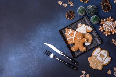 Christmas decorations and gingerbreads on a dark concrete table. Preparing and decorating the house for holiday