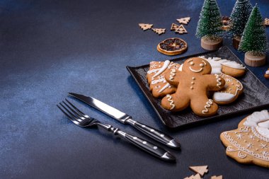 Christmas decorations and gingerbreads on a dark concrete table. Preparing and decorating the house for holiday
