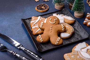 Christmas decorations and gingerbreads on a dark concrete table. Preparing and decorating the house for holiday