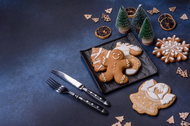 Christmas decorations and gingerbreads on a dark concrete table. Preparing and decorating the house for holiday